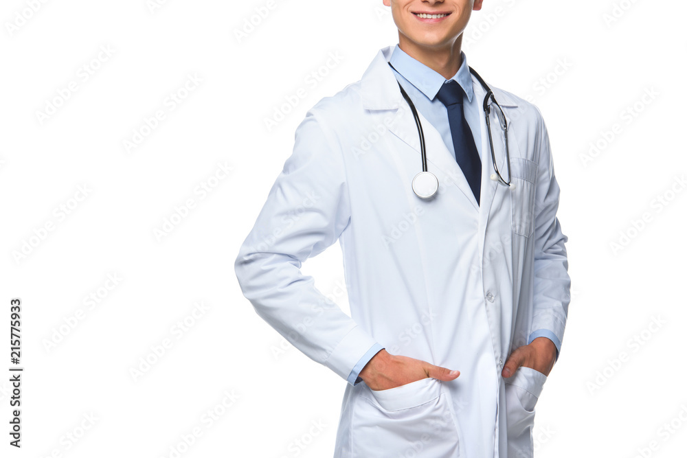 cropped shot of young doctor with hands in pockets of medical coat isolated on white