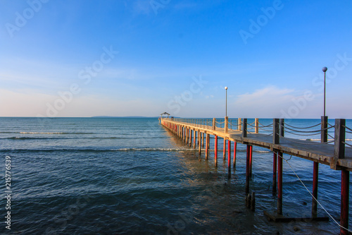 Concrete jetty into the sea on blue sky background