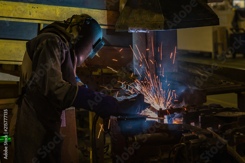 Industrial worker is welding repair his work in factory