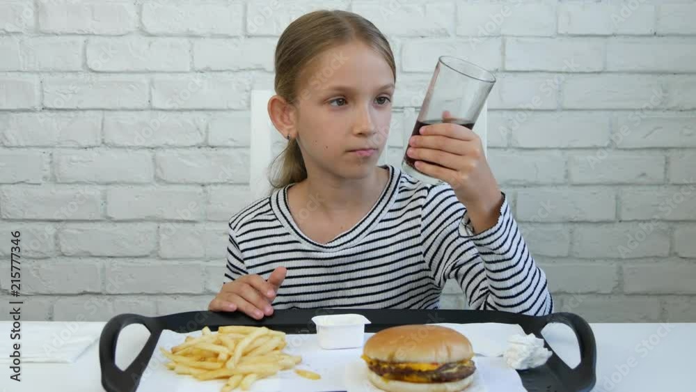 Child Eating Hamburger Drinking Juice in Restaurant, Kid and Fast Food, Children Child Eating Hamburger Drinking Juice in Restaurant, Kid and Fast Food, Children