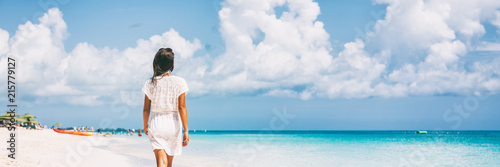 Canvas Print Luxury beach vacation travel woman relaxing on paradise tropical holiday destination for sun getaway