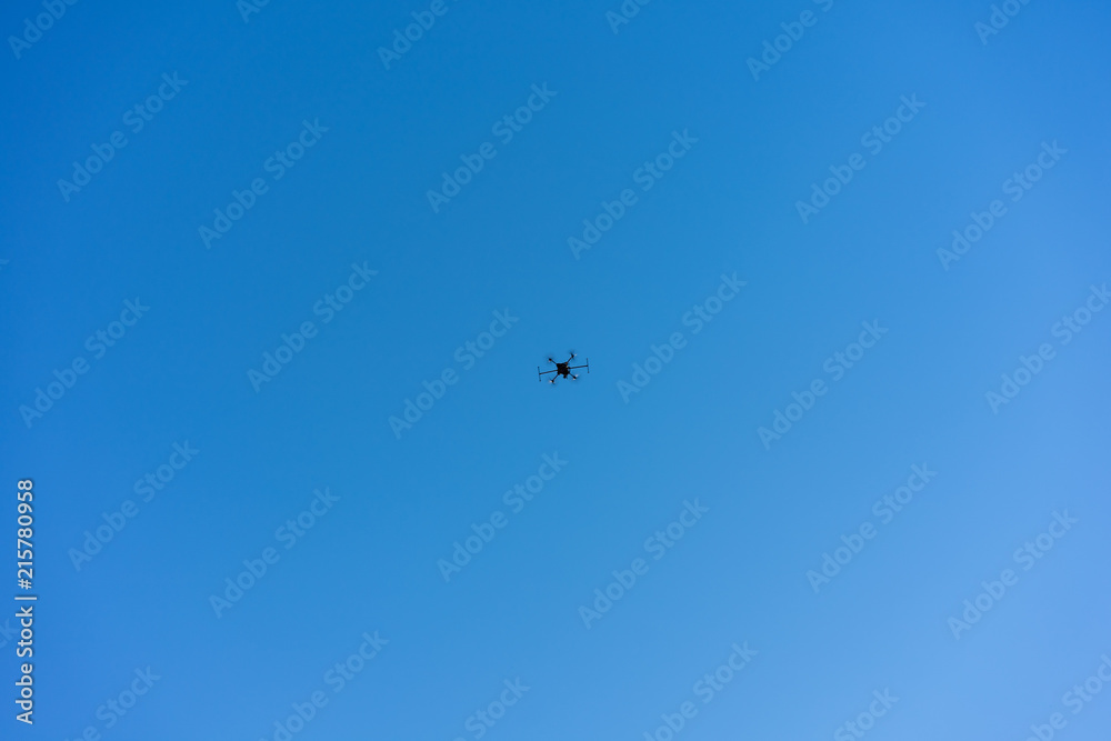 drone flying with blue sky low angle view drone flying with blue sky low angle view