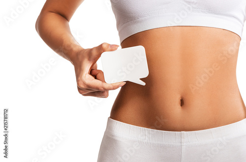 Woman holding question mark over her abdomen 