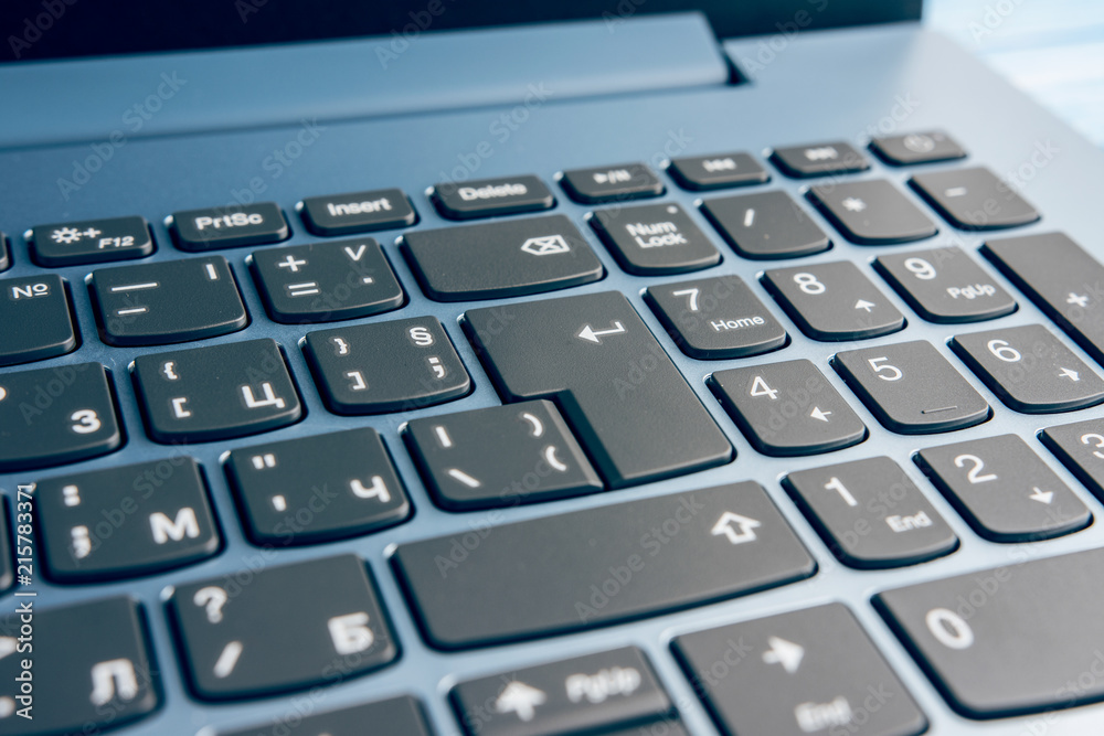 Gradient Blue Brand New Laptop With Balck Keyboard Closeup On Blue Wood Surface Gradient Blue Brand New Laptop With Balck Keyboard Closeup On Blue Wood Surface