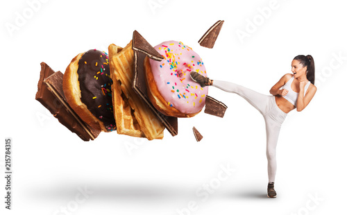 Fit young woman fighting off sweets and candy