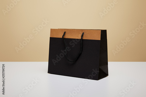 one black shopping bag on white table