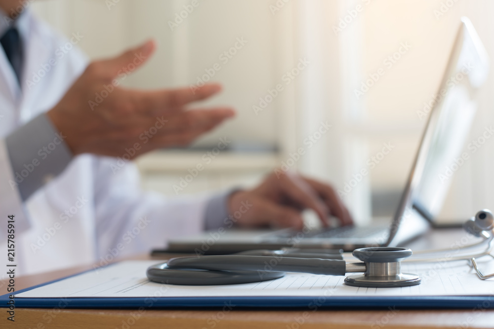 Doctor working on laptop computer Doctor working on laptop computer