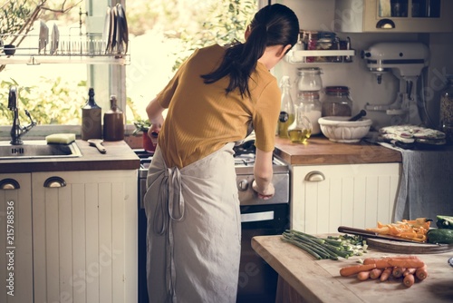 Asian woman cooking in her kitchen