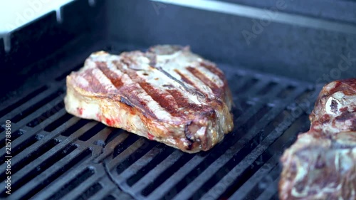 4K footage of ribeye steak grilling and slicing
