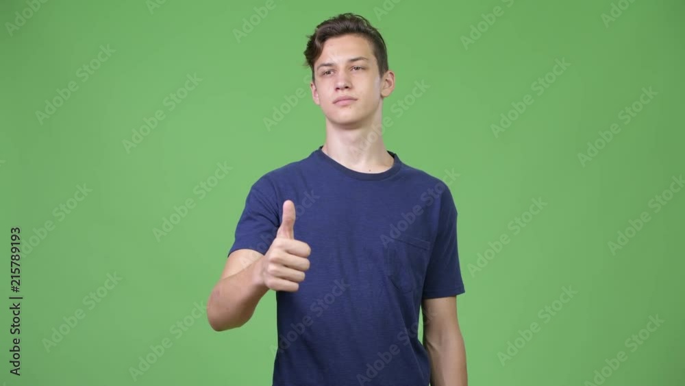 Young handsome teenage boy giving thumbs up Young handsome teenage boy giving thumbs up