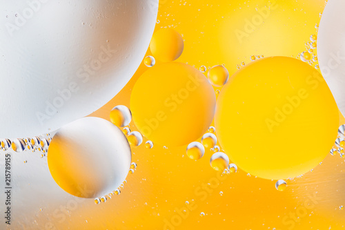Beautiful color abstract background from mixied water and oil. Pastel colored abstraction. Yellow and white background from water bubbles.