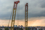 Construction cranes against a thunderstorm in the city of Kiev, Ukraine.