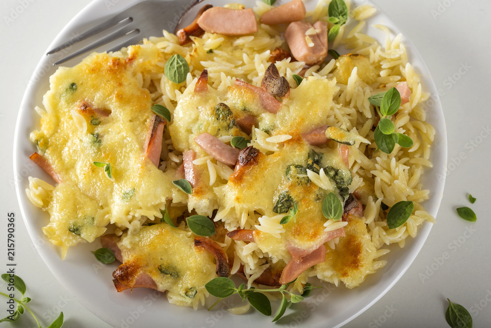 Baked risotto with mozzarella and sausages on plate Baked risotto with mozzarella and sausages on plate
