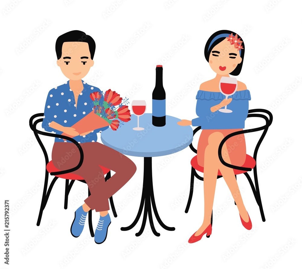 Pair of young man and woman sitting at table and drinking red wine  together. Couple in