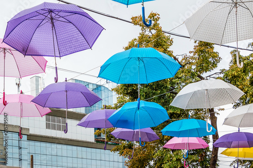 Multicolored umbrellas that create festive mood on the street