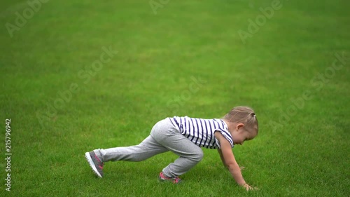4K footage of little girl doing some sport on grass