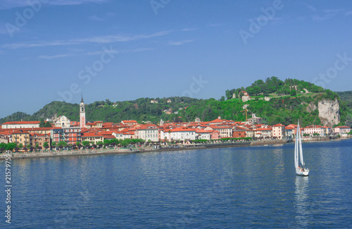 sailboat heads towards Arona, a beautiful town overlooking Lake Maggiore, Piedmont, Italy photo