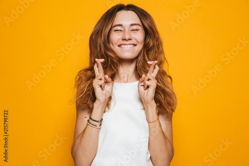Portrait of an excited young girl holding fingers photo