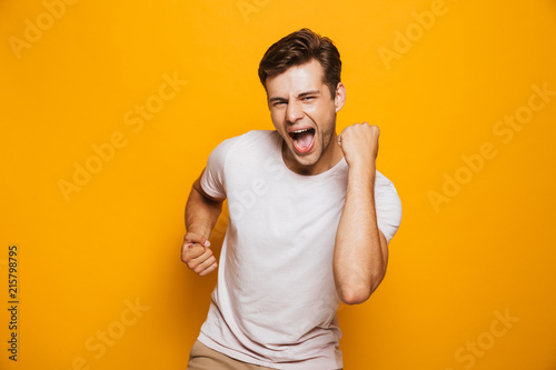 Portrait of a cheerful young man celebrating photo