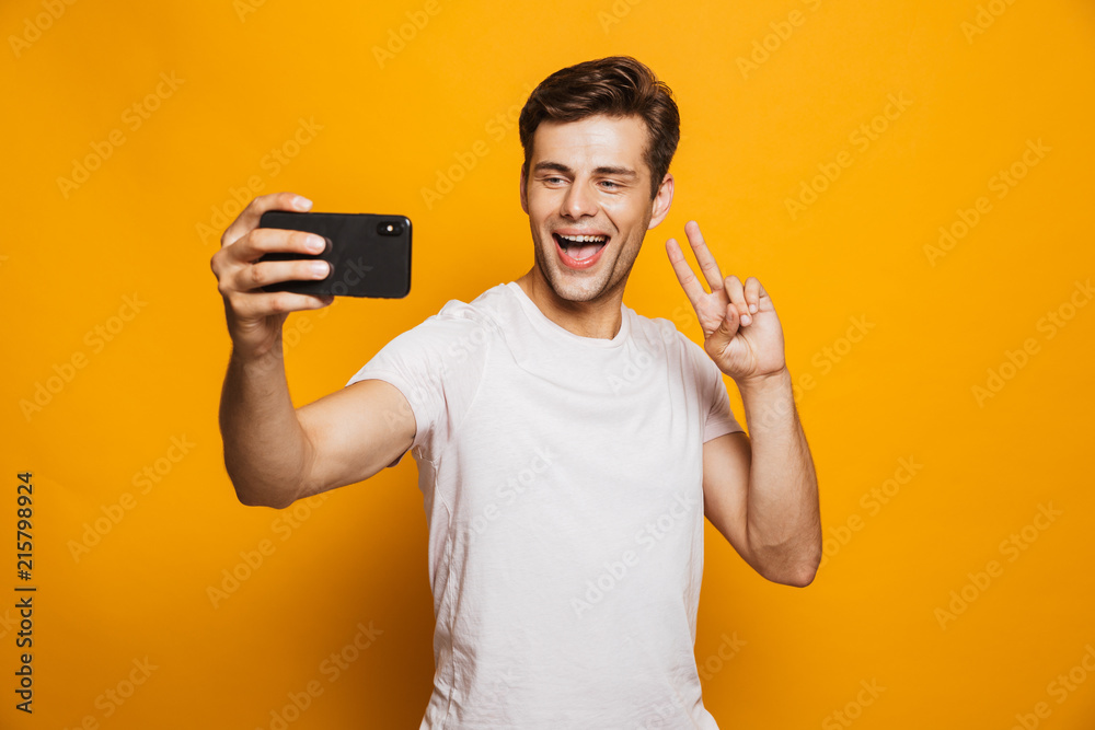 Portrait of a happy young man taking a selfie Portrait of a happy young man taking a selfie