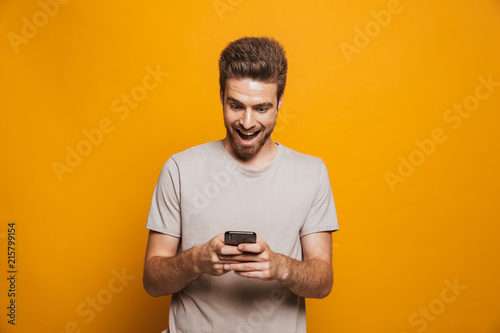 Portrait of a happy young man using mobile phone