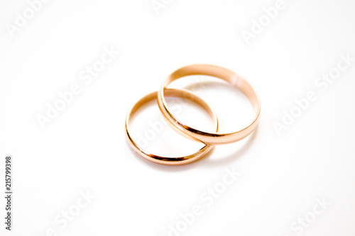 love, family, celebration, ceremony concept -wedding symbols two golden rings on white background