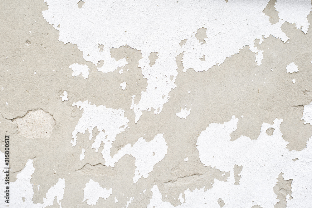 Wall with white peeling plaster. Close up