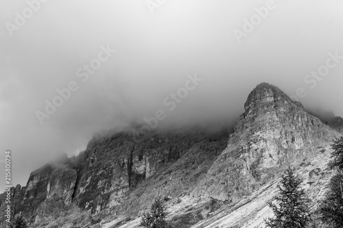 Mountain peak in black and white disappearing in dramatic, thick storm clouds. Cadini di Misurina, Dolomites, Italy