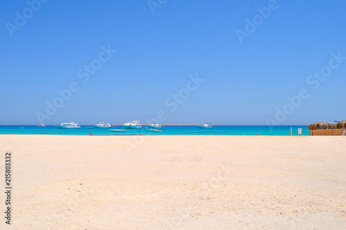 Mahmya island at Red Sea in Egypt, idyllic beach of Mahmya island with some boats in turquoise water, Egypt