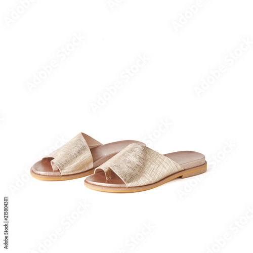Womens golden one finger flat sandals. Studio shot, white background