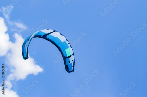 parachute scissors against the blue sky on a sunny day