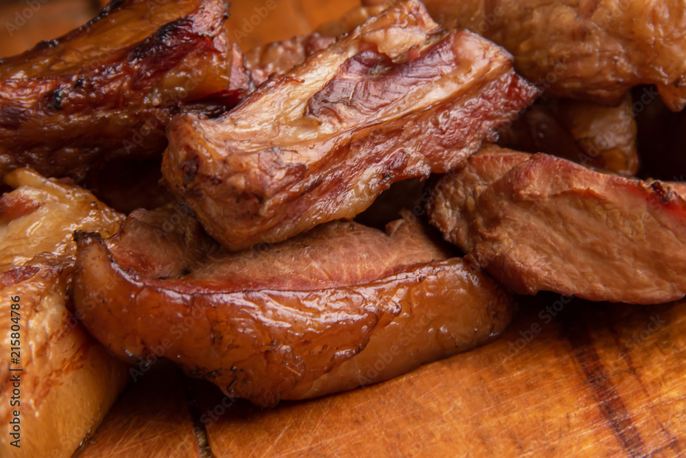 Smoked pork ribs and meat on wooden board Smoked pork ribs and meat on wooden board