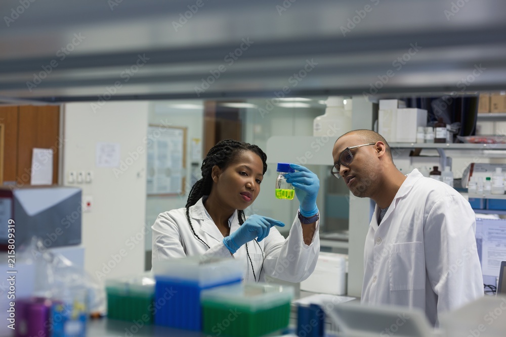 Scientists experimenting solution in laboratory Scientists experimenting solution in laboratory