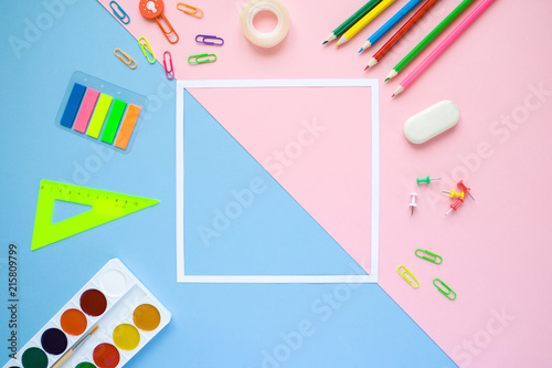 stationery flat lay on pink and blue background