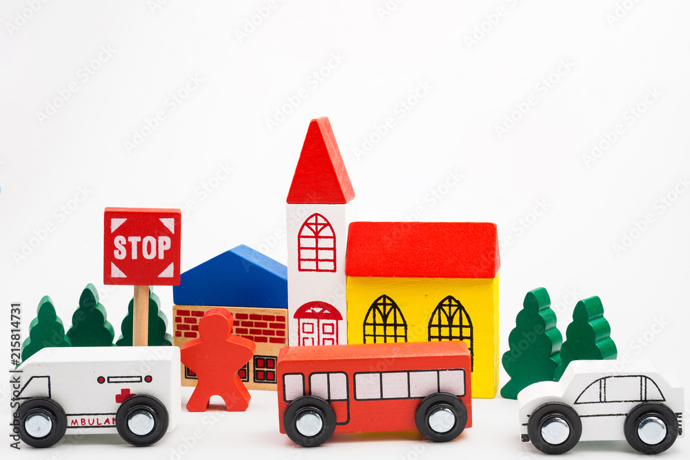 Road traffic with wooden toy cars in the town on white background, safety and traffic regulations concept, backgrounds.Transportation system concept.
