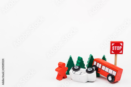Wooded toy car are crashed. Accident road traffic with wooden toy cars in the town on white background, safety and traffic regulations concept, backgrounds.Transportation system concept.