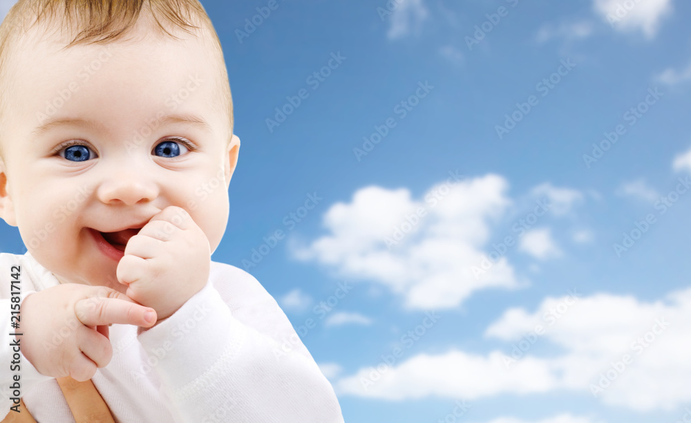 childhood and people concept - close up of sweet little baby over sky background childhood and people concept - close up of sweet little baby over sky background