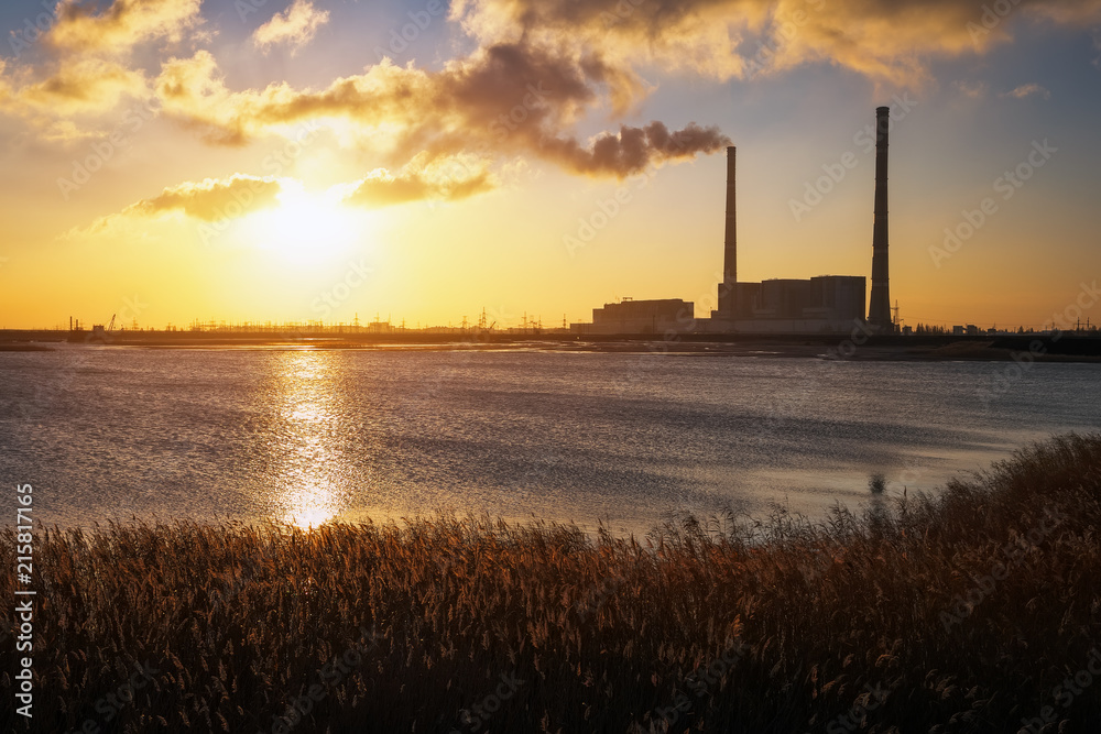 Beautifull landscape with thermal power plant, lake and sunset sky.