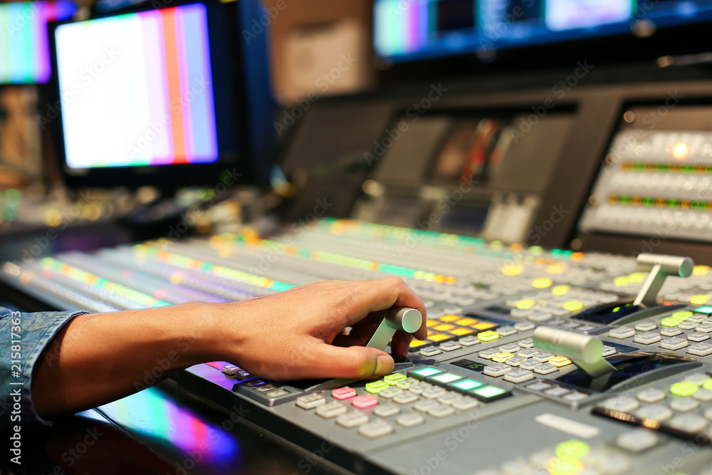 Fototapeta premium Hands on dissolve of Switcher buttons in studio TV station, Audio and Video Production Switcher of Television Broadcast.