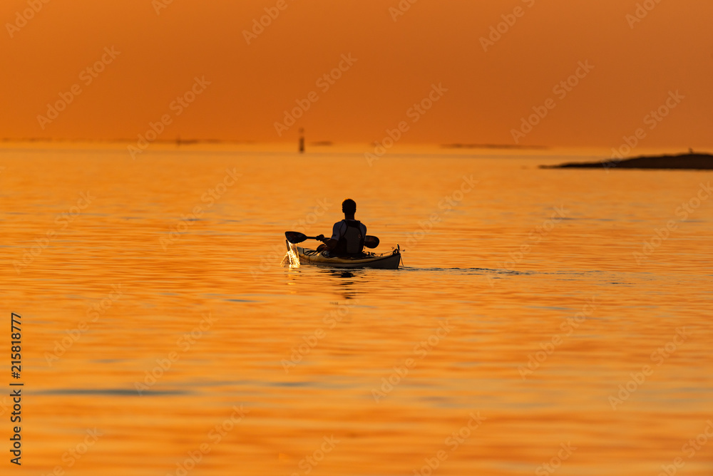 Kayak in sunset at sea