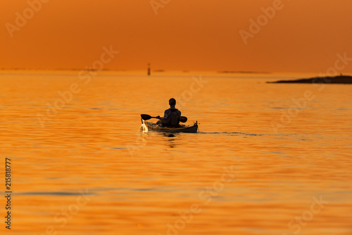 Kayak in sunset at sea