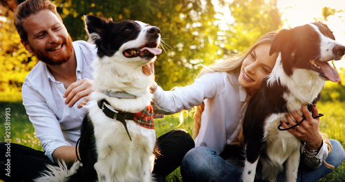 Photography Beautiful couple cuddling and walking dogs outdoors