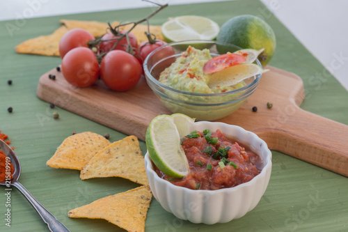 tortilla chips with dips, spices and vegetables