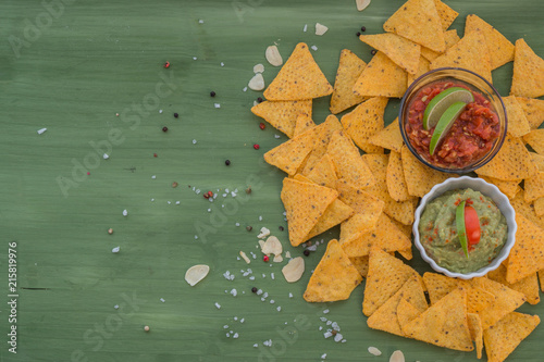 tortilla chips with dips, spices and vegetables