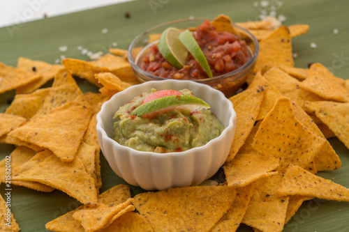 tortilla chips with dips, spices and vegetables
