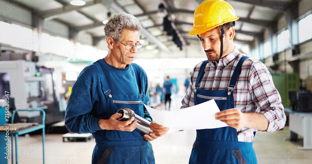 Team Of Engineers Having Discussion In Factory Team Of Engineers Having Discussion In Factory