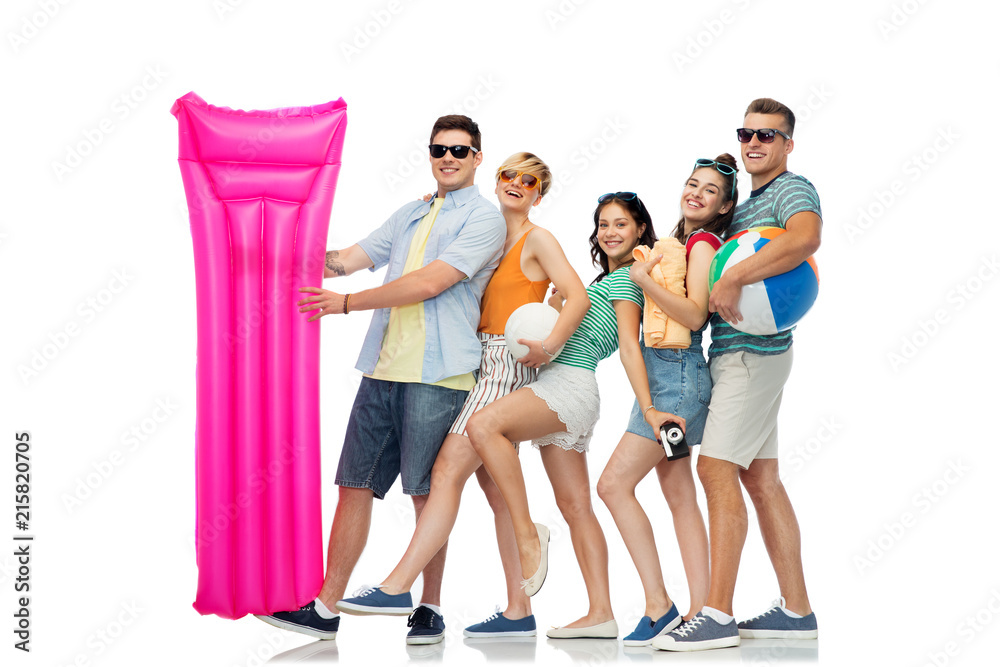 Obraz premium summer holidays and people concept - group of happy smiling friends in sunglasses with beach ball, volleyball, towel, camera and air mattress over white background
