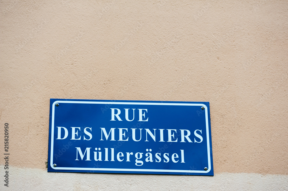 Rue des Meuniers - Mullergassel street sign on the building facade in Strasbourg, Alsace France Rue des Meuniers - Mullergassel street sign on the building facade in Strasbourg, Alsace France