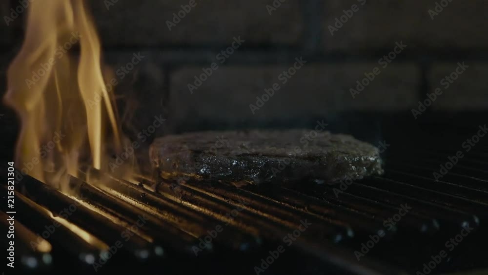 Chief hands cooked the meat on the grill turning using the spatula slow ...