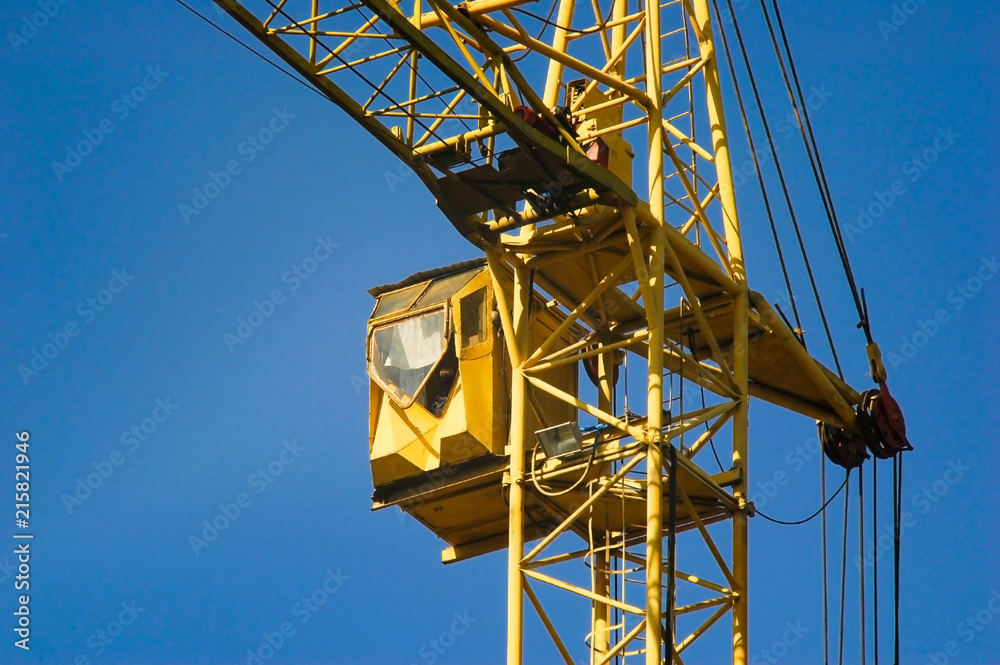 yellow cab of a construction hoisting crane